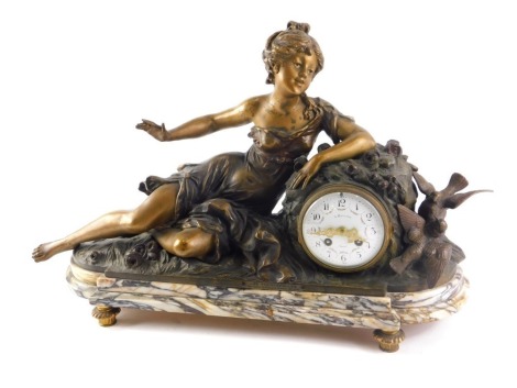 A late 19thC French bronzed spelter figural mantel clock, model in the form of a reclining lady with birds etc. the enamel dial signed A Raymond, on a marble base, 59cm wide.