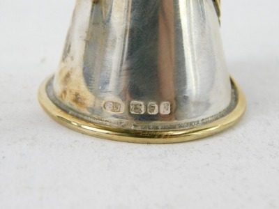 A Queen Elizabeth II silver candle snuffer by Sarah Jones, the tapering top with silver gilt decoration of crossed feathers, stamped SJ, London 1981, 24cm long. - 2