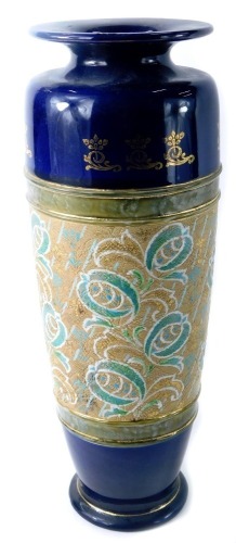 A Royal Doulton Lambeth stoneware urn, with a fluted circular top on a royal blue ground with gilt decoration, with floral scroll swags, stamped to underside, 34cm high.