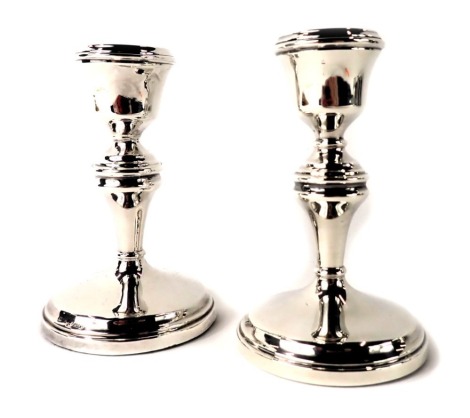 A pair of George V silver dwarf candlesticks, each of plain design on weighted base, Birmingham 1926, 11cm high.