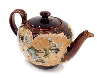 A Doulton Lambeth stoneware teapot, with brown treacle glaze, and a design of flowers and leaves, 14cm high.