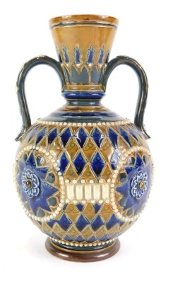 A Doulton Lambeth stoneware two handled vase, with sgraffito decoration of roundels within geometric brown and blue bands, in the manner of George Tinworth, impressed marks to underside, 20cm high.