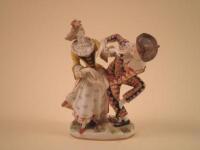 A Dresden porcelain group of a lady and a Harlequin on an oval base