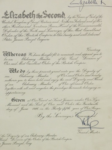 A framed Grant of the Dignity of an Ordinary Member of the Civil Division of the Order of the British Empire, (OBE) to Peter James Baizot, Esquire, bearing signature of Elizabeth II, 38cm x 32cm.