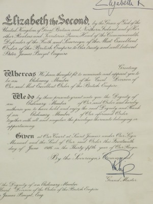 A framed Grant of the Dignity of an Ordinary Member of the Civil Division of the Order of the British Empire, (OBE) to Peter James Baizot, Esquire, bearing signature of Elizabeth II, 38cm x 32cm.