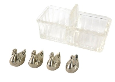 A pressed glass double salt or cruet, and four silver plated swan place name or menu holders. (5)