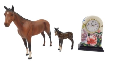 Three items of named ceramics, comprising a Royal Doulton matt glazed large horse, a Beswick foal, and an Old Tupton ware mantel clock. (3)