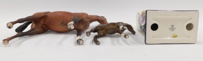 Three items of named ceramics, comprising a Royal Doulton matt glazed large horse, a Beswick foal, and an Old Tupton ware mantel clock. (3) - 3