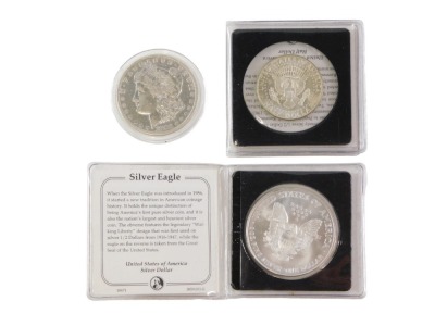 Three American coins, comprising a John F Kennedy silver half dollar in presentation pack with certificate of authenticity, a silver eagle silver dollar dated 1995 in presentation case with certificate of authenticity and a silver one dollar 1883. (3)