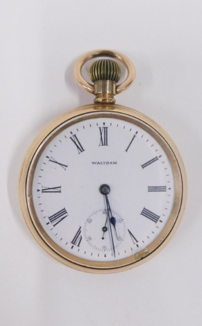 A Waltham gold plated pocket watch, with white enamel dial and bezel wind.