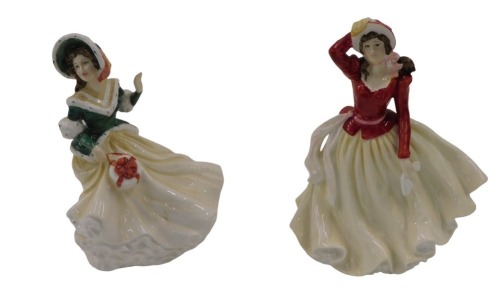 Two Royal Doulton figures, Alice Lady of The Year 1999, and The Royal Doulton Classics Christmas Day 2002, 21cm high respectively.