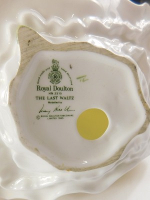 A Wedgwood blue Jasperware biscuit barrel, lacking mounts, 15cm high, a Royal Doulton figurine of Invitations, and another The Last Waltz. (3) - 3