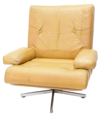 A 1960s/70s brown leather swivel armchair, with padded back and seat, on metal revolving X shaped base, no labels. (AF)