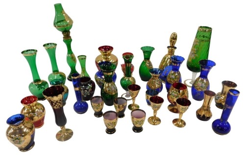 A quantity of Venetian coloured glass vases, etc., each decorated in gilt and with raised coloured enamels.