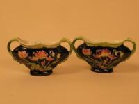 A pair of Austrian pottery two handled small vases