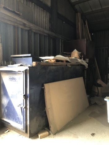 A bonded white diesel storage tank and further red diesel storage tank.