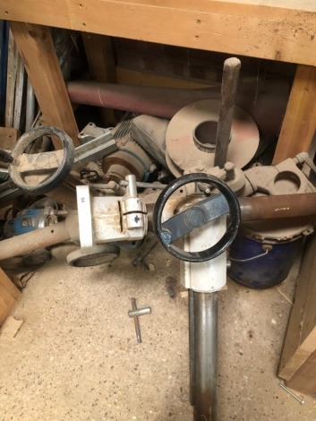 Various attachments for woodworking machinery, old router and other contents of rack.