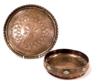 An Arts & Crafts hammered copper bowl, with applied white metal floral diamonds, 20.5cm wide, together with a copper tray with engraved decoration, 28cm wide. (2)