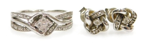 A silver and diamond dress ring, in a cross over setting, size N, together with a pair of silver and diamond earrings, 6.1g.