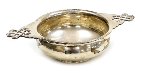 A George V silver porringer, or sweetmeat dish, for Asprey of London, with pierced foliate scroll handles, maker's mark indistinct, London 1927, 7.19oz.