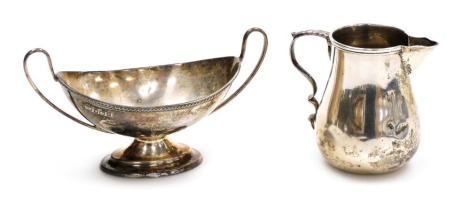 A Victorian silver cream jug, with a double loop handle, Stokes & Ireland Ltd, Birmingham 1895, together with an Adam style twin handled pedestal salt of boat form, Sheffield 1908, 4.18oz.