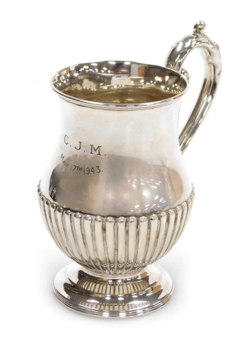 A Victorian silver tankard, of semi fluted baluster form, later presentation engraved, John Round & Son Ltd, Sheffield 1885, 4.81oz.