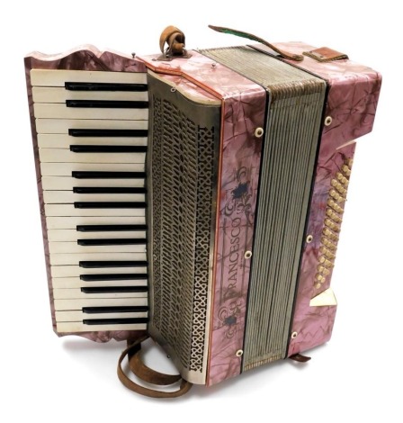 A late 19thC German Francesco piano accordion, with pink simulated mother of pearl casing and forty-eight buttons, 46cm wide.