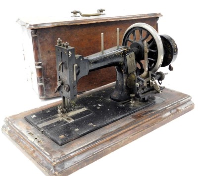 A late 19thC Frister and Rossmann sewing machine, serial number 22550/35**50, wooden cased.