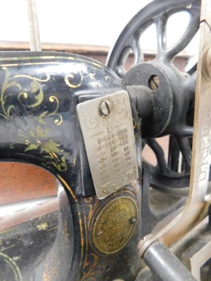 A late 19thC Frister and Rossmann sewing machine, serial number 22550/35**50, wooden cased. - 2