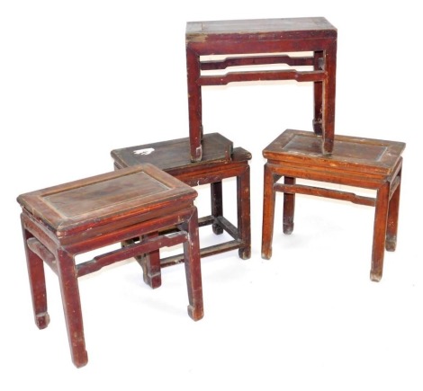 Four Chinese hardwood occasional tables, of rectangular section, raised on square legs, 49cm and 53cm high, 49cm-52cm wide.