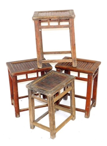 Four Chinese hardwood stools, with slatted seats, 47cm-50cm high, 38cm-40cm wide.