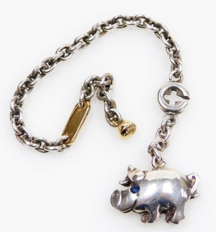 A de Grisogono silver and 18ct gold keyring, with a pig fob, set with a blue stone set eye, with pouch.