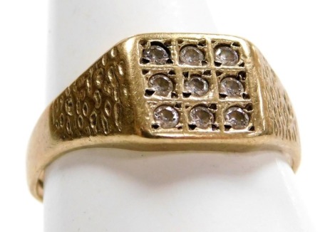 A 9ct gold and gem set gentleman's signet ring, possibly white sapphires, set with nine stones in a square compartmented design, size X, 3.8g.