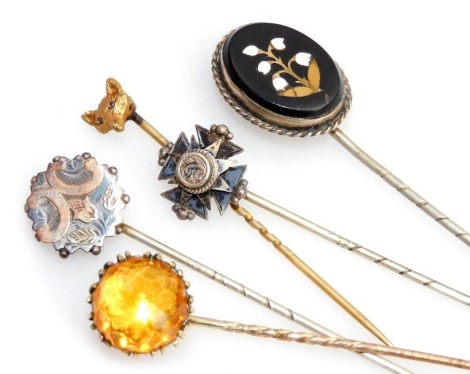 Victorian and later tie pins, an Italian pietra dura pin decorated with lily of the valley, fox's head pin, and a yellow paste set pin. (5)