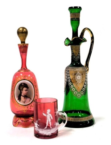 A late 19thC Continental cranberry glass scent bottle and stopper, with a reserve roundel painted with the bust portrait of a lady, within a gilt foliate border, 24cm high, together with a Bohemian green glass bottle and stopper, with gilt enamel net deco