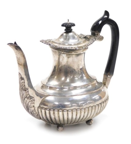 A Victorian silver semi fluted coffee pot, with embossed foliate decoration to the top rim, raised of four ball feet, Edward Barnard and Sons, London 1898, 25¼oz.