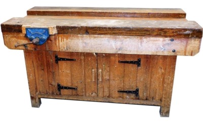 A pine work bench, with a Record No. 52B vice, with cupboards below, 80cm high, 152cm wide, 77cm deep.