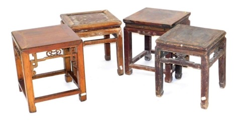 Four Chinese hardwood stools, variously carved, raised on square legs.