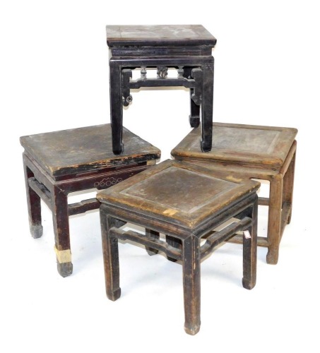 Four Chinese hardwood stools, variously carved, raised on square legs.