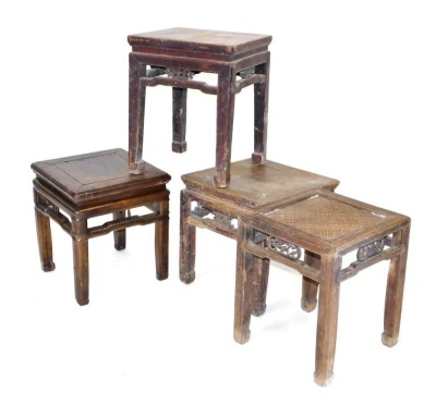 Four Chinese hardwood stools, three with hardwood tops, one with a rattan top, raised on square legs.