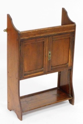 A Victorian mahogany and oak wall hanging cupboard, with a single shelf, over a pair of cupboard doors, raised on trestle ends, 60cm high, 57cm wide, 16cm deep, and an oak wall hanging cupboard, with a galleried top over two doors, with a shelf below, 65c - 2