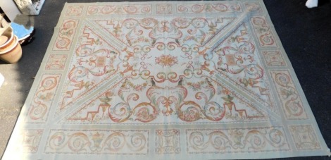 An Aubusson type cream and pale green ground rug, decorated with a central floral motif and urns, the outer field with birds, urns and foliate scrolls, within a panelled border of floral and foliate motifs, 352cm x 276cm.