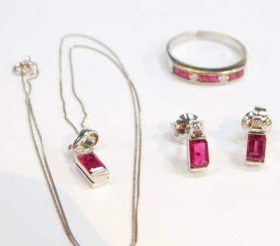 An 9ct white gold ruby and diamond jewellery set, comprising ring, necklace and earrings, the ring set with six square cut rubies, and three round brilliant cut diamonds, size P½, the pendant with single ruby, rectangular cut drop and tiny diamond mark to - 2