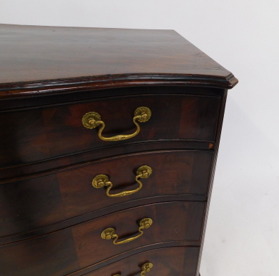 A George III figured mahogany serpentine fronted chest, of four drawers with triple veneer fronts and brass swans neck handles, with reeded flat pilasters, on shaped bracket feet, 82cm high, 93cm wide, 52cm deep. - 5