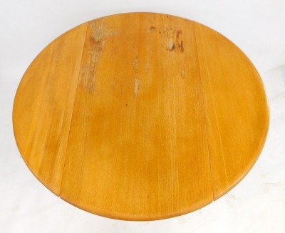 An Ercol drop leaf dining table, the circular top with rounded edge, raised on square tapering legs, 71cm high, 97cm wide, together with a set of four Ercol model 1381 dining chairs. (5) - 2