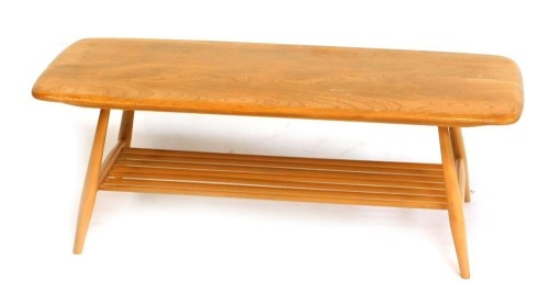 An Ercol light elm coffee table, the rectangular top with a rounded edge, above a slatted under tier, on cylindrical tapering legs, bearing label, 37cm high, the top 100cm x 46cm.