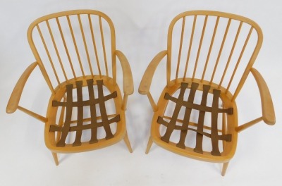 A pair of Ercol beech framed armchairs, model 334, each with a loose floral upholstered seat and back, bearing label, back 77cm high, 65cm wide. - 2