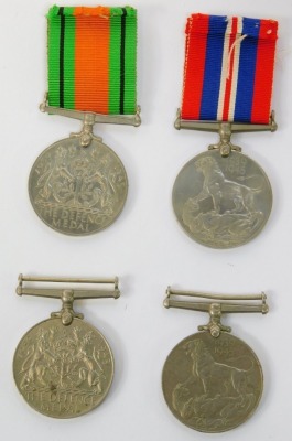 Four WWII medals, comprising three 1939-45 War medals and a Defence medal, two with ribbons. - 2