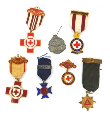 A group of Red Cross enamelled medals, named to M Turner 4482, Hilda Wollen 6851, HM Simmons 25718 and another numbered 32455, together with a medallion from the Royal Society for the Prevention of Accidents 10 years safe driving, driving 1946, Primitive