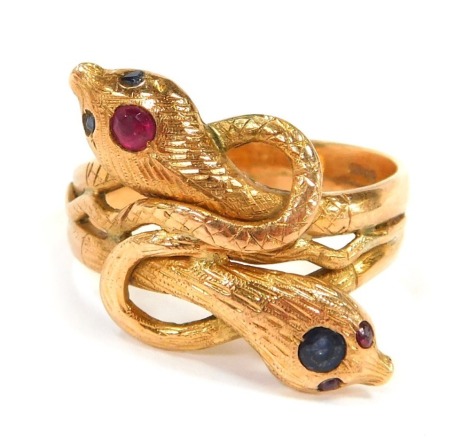 A 9ct gold serpent dress ring, set with rubies and sapphires, with cross over twist design, size S½, 7.3g all in.